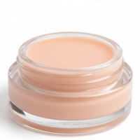 Jar of beige cream on a white background