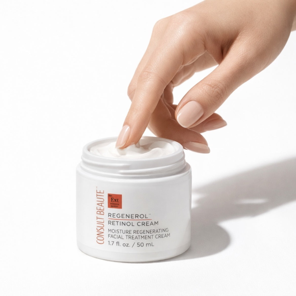 Hand opening a jar of Consult Beaute Regenerol Retinol Cream on a white background