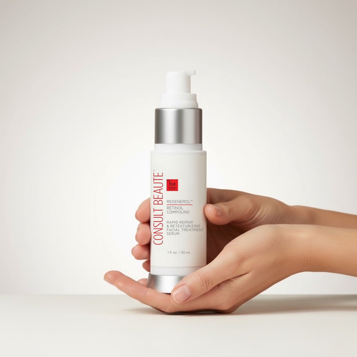 Hand holding a skincare bottle with 'Consulbeaute' branding on a light background.  Regenerol Retinol Compound.  Rapid Repair and Retexturizing Facial Serum.  Consult Beaute by Dr Terry Dubrow and Heather Dubrow. 