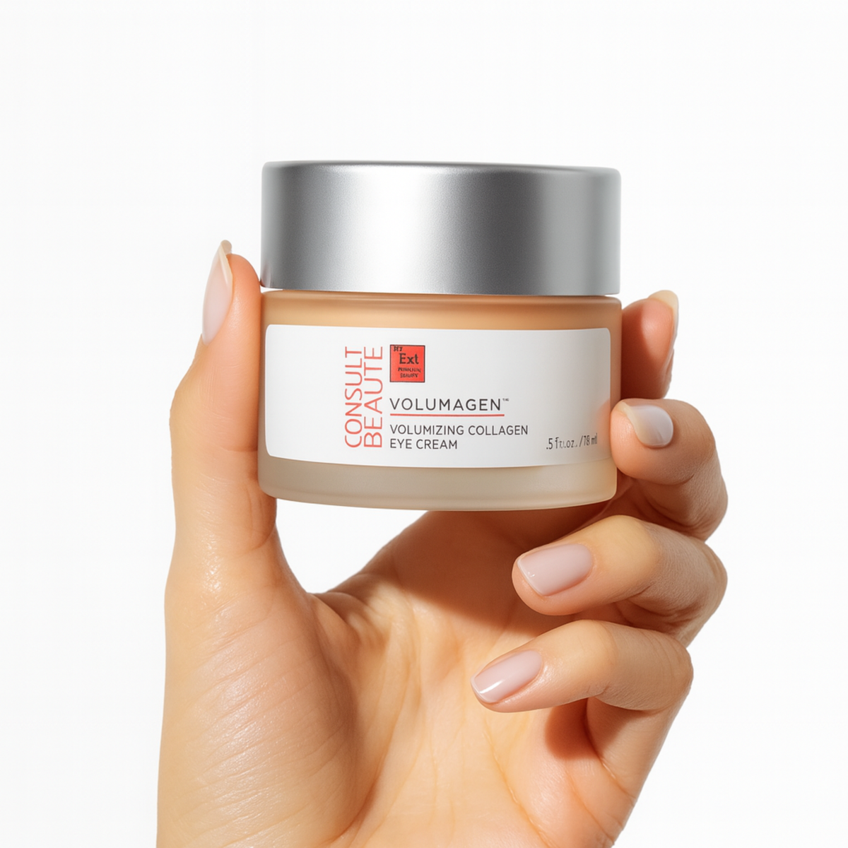 Hand holding a jar of Volumagen eye cream against a white background.  Alternative to facial fillers.  Consult Beaute by Dr Terry Dubrow and Heather Dubrow.